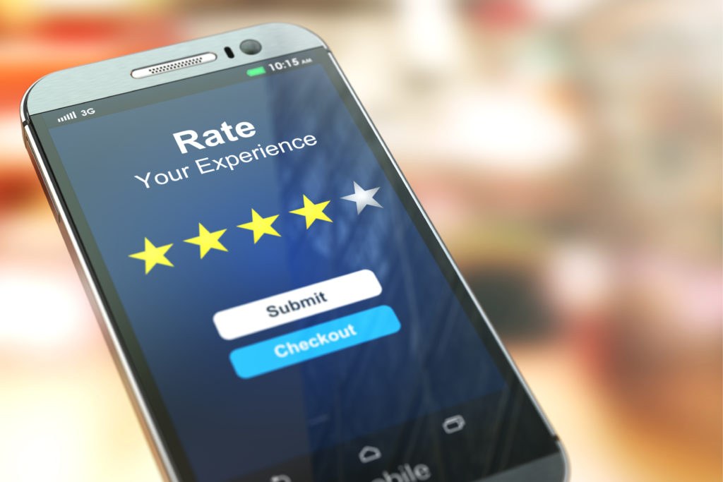 Person writing feedback on a mobile phone app