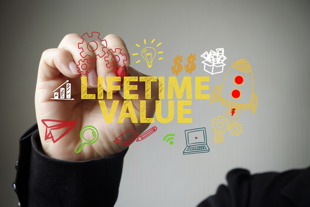Mobile marketer analyzing app user value metrics on a laptop