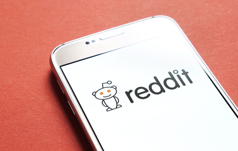 Mobile game developer reviewing app screenshots with the gaming community