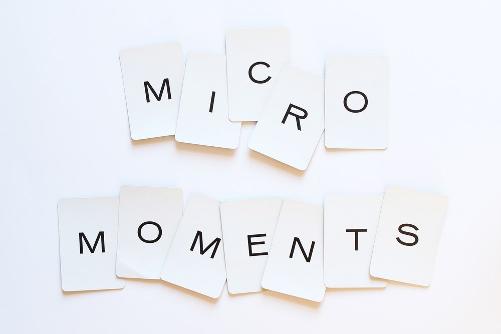 Mobile user scrolling on a phone illustrating micro-moment behavior
