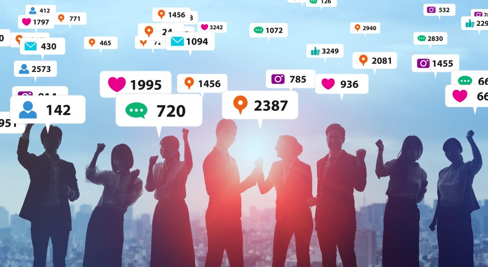 Friends sharing a mobile app recommendation in a casual setting