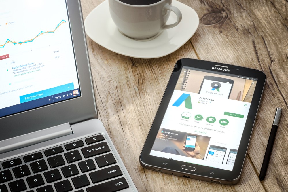 Developer reviewing Google AdWords campaign setup on a laptop