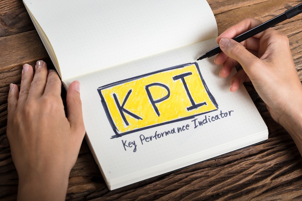 Mobile marketer reviewing KPI metrics on a laptop
