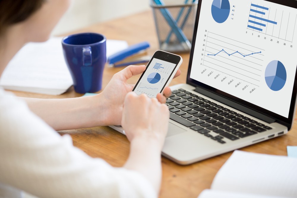 Person reviewing financial data on a smartphone