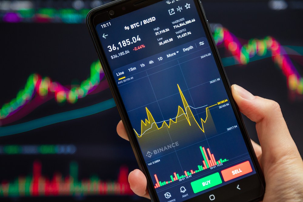 Bitcoin coin and cryptocurrency trading charts on a screen