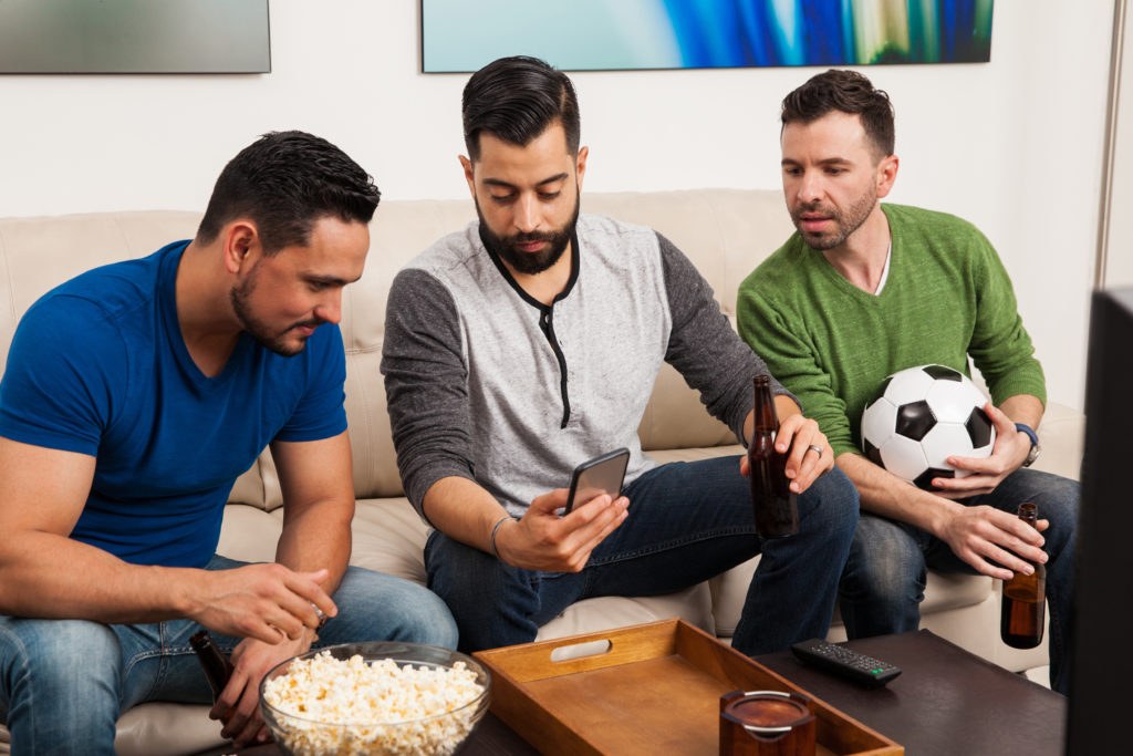 Person using a smartphone to browse a sports app