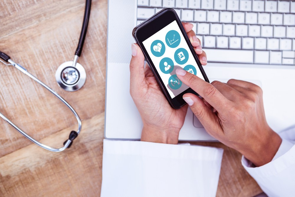 Healthcare professional reviewing patient data on a tablet