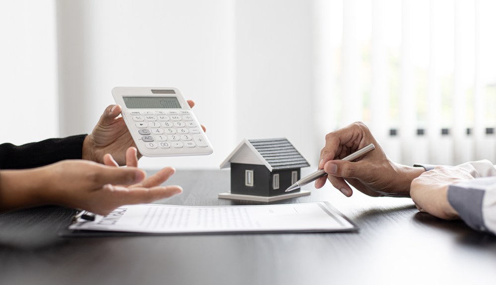 Couple reviewing real estate app options on a tablet at home
