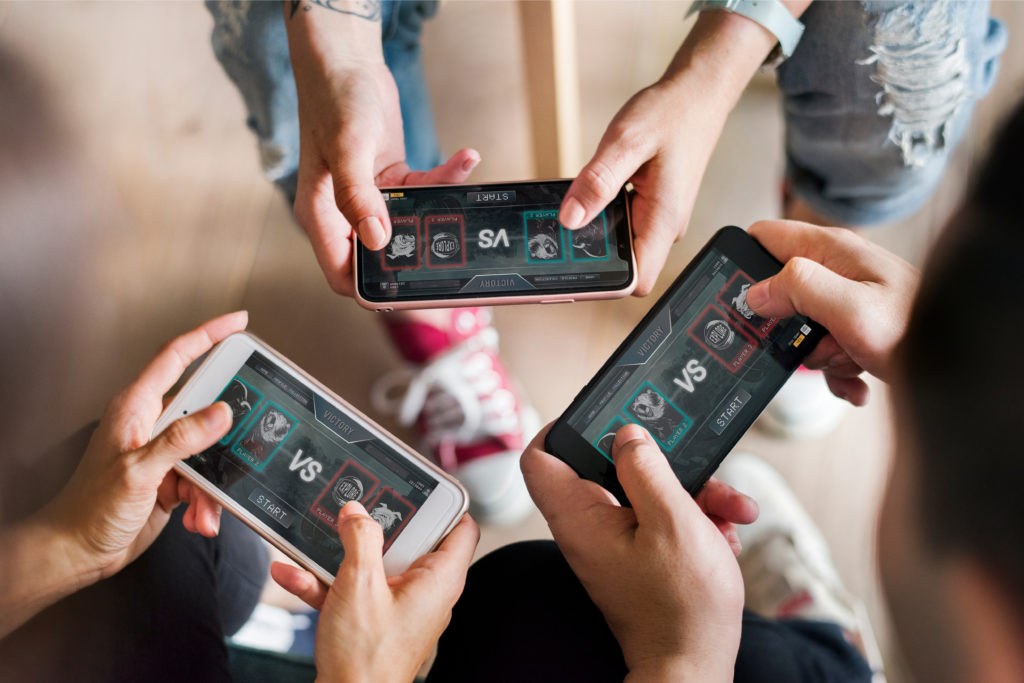 Person deeply engaged playing an addictive mobile game