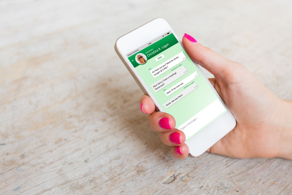 In-app messaging screen with photo and emoji attachment options