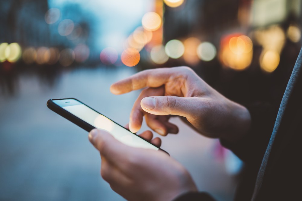 User reviewing mobile app analytics and feedback on a device