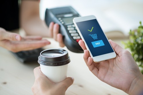 Person completing a fast mobile payment transaction on smartphone