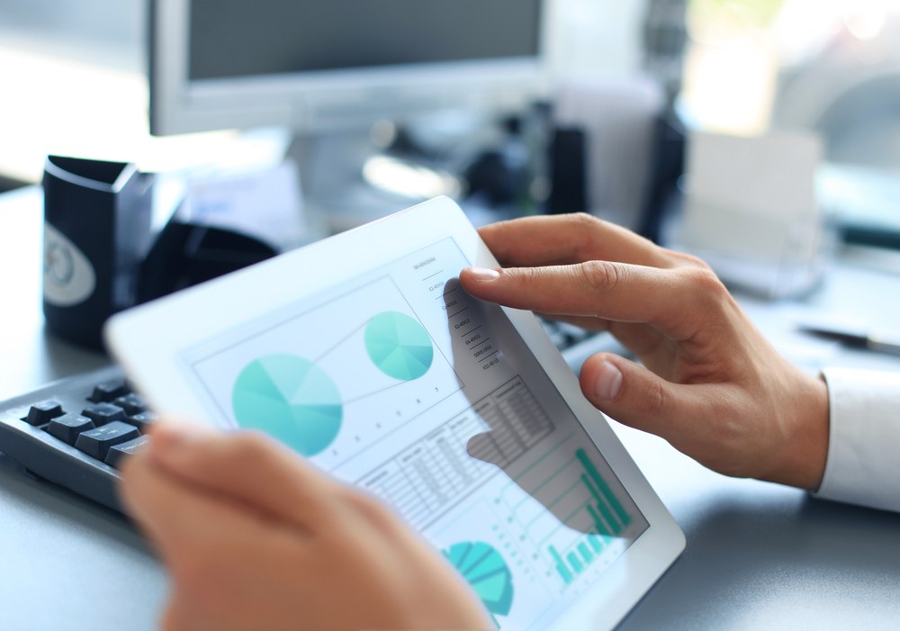 Marketer planning a mobile app promotion strategy on a laptop