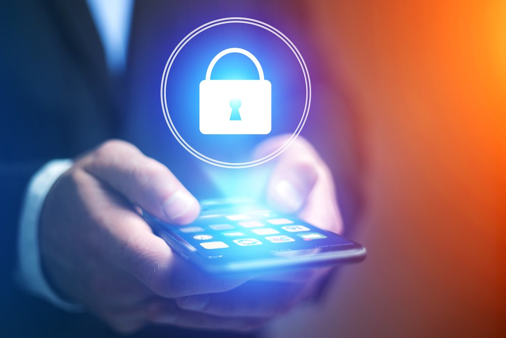 Developer reviewing mobile app security code on a laptop