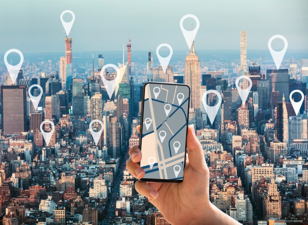 Smartphone displaying a location pin on a map for mobile ad targeting