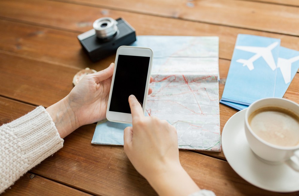 Traveler planning a trip on a laptop at home