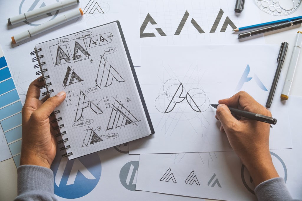 Graphic designer making draft on Logo product trademark