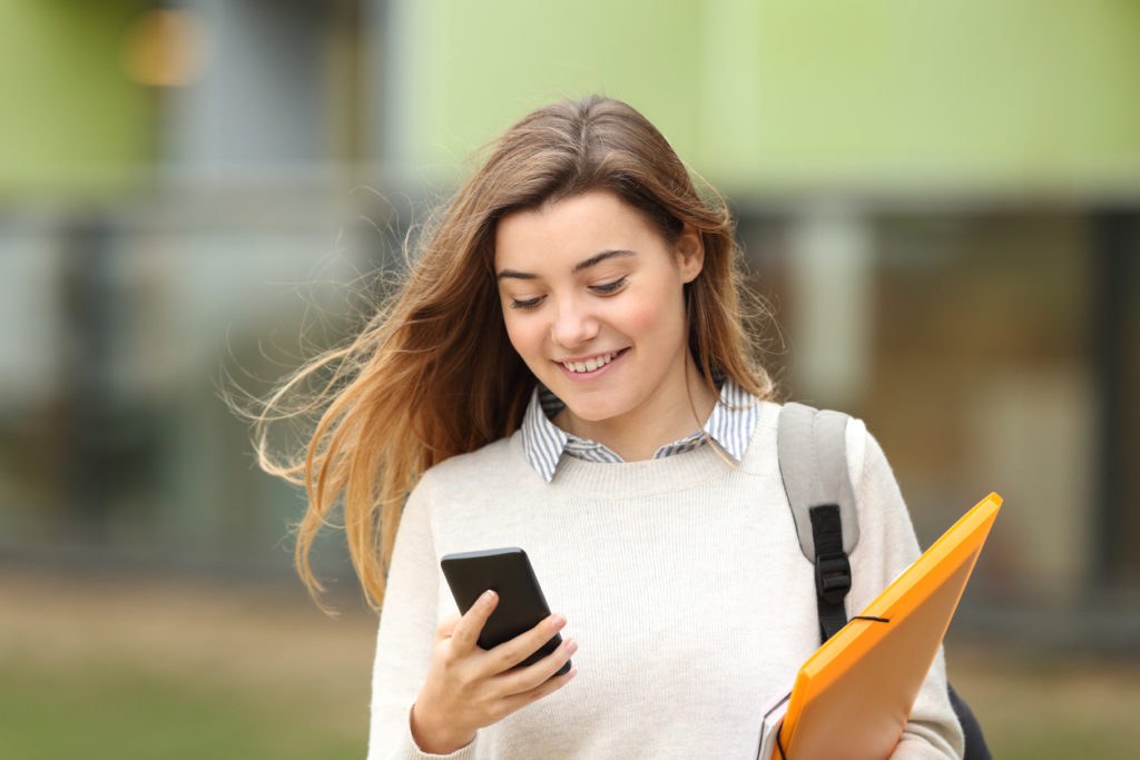 Student using a smartphone on a university campus