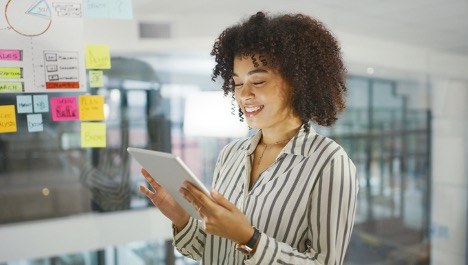 businesswoman-checking-apps-on-digital-tablet-in-an-office-marketing-strategies-concept