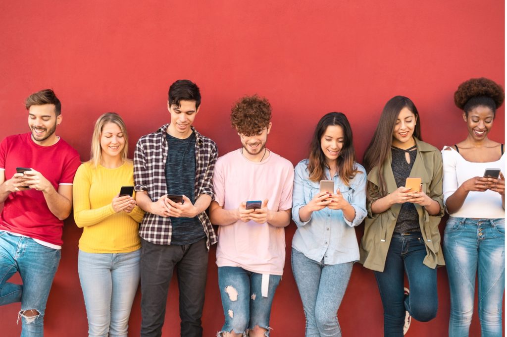 group-of-gen-z-friends-using-mobile-smartphone-outdoor