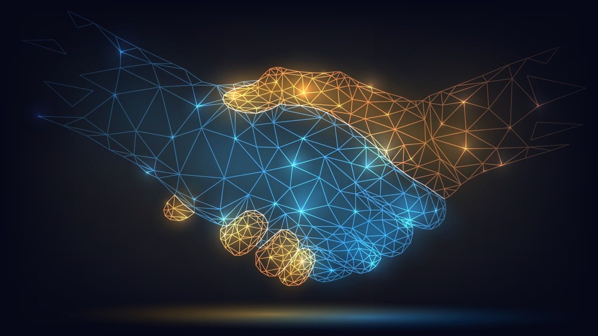 Two business partners shaking hands over a co-marketing agreement