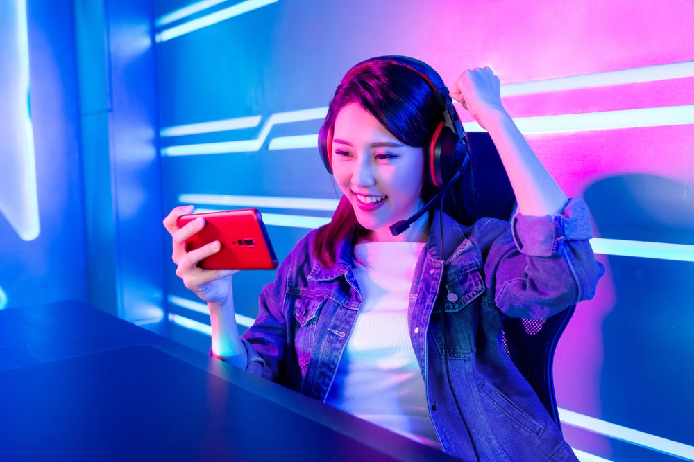 Mobile gamer earning rewards through a play-to-earn app