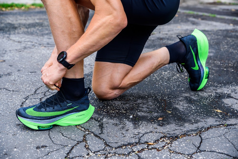 Runner outdoors using the Nike Run Club app on a phone