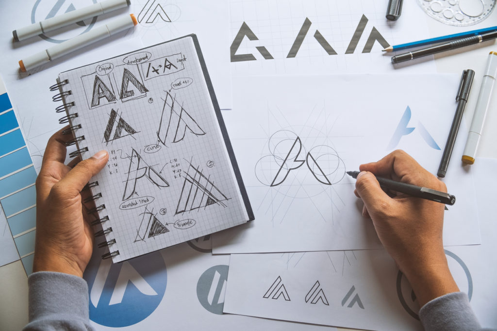 Graphic designer making draft on Logo product trademark 
