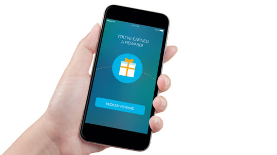 A hand holding a mobile phone with a reward screen on white background.