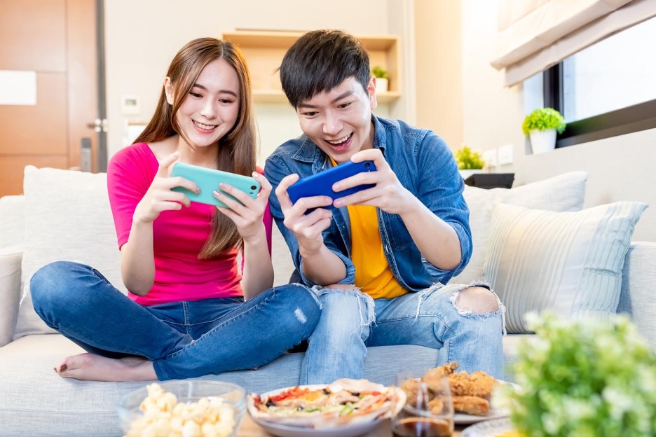 Couple playing mobile games together
